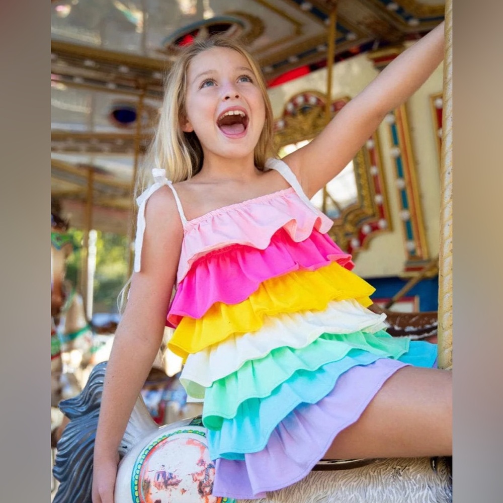 Lola + The Boys presents a pastel rainbow-colored tiered dress with tie straps
